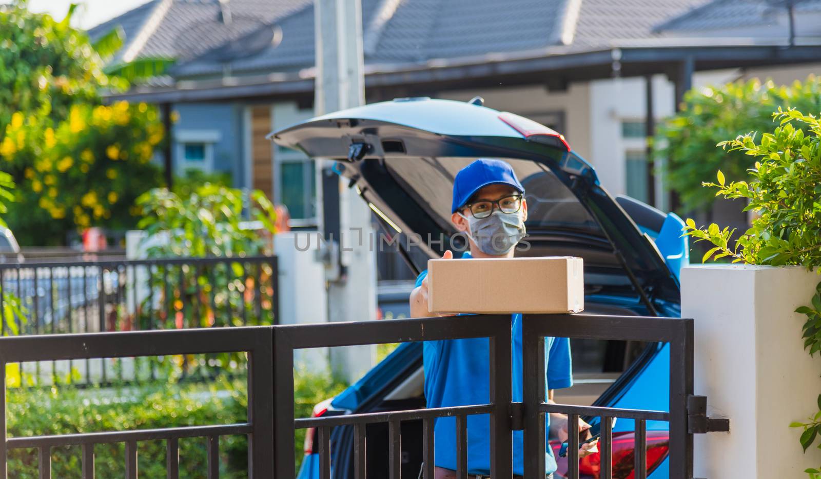 delivery man with box he protective face mask, service customer  by Sorapop