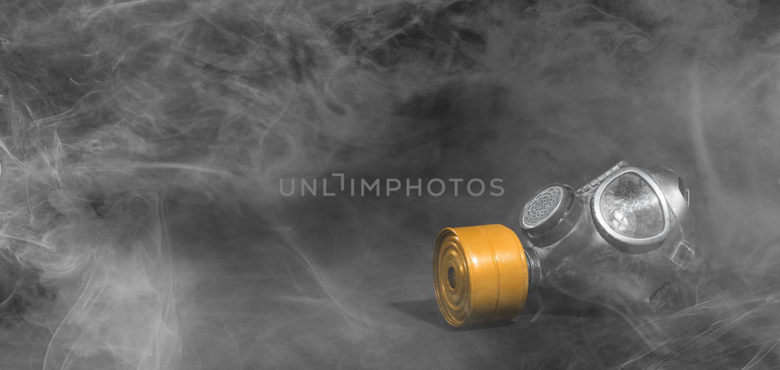Vintage gasmask isolated on black background - Smoke in the room - Orange filter
