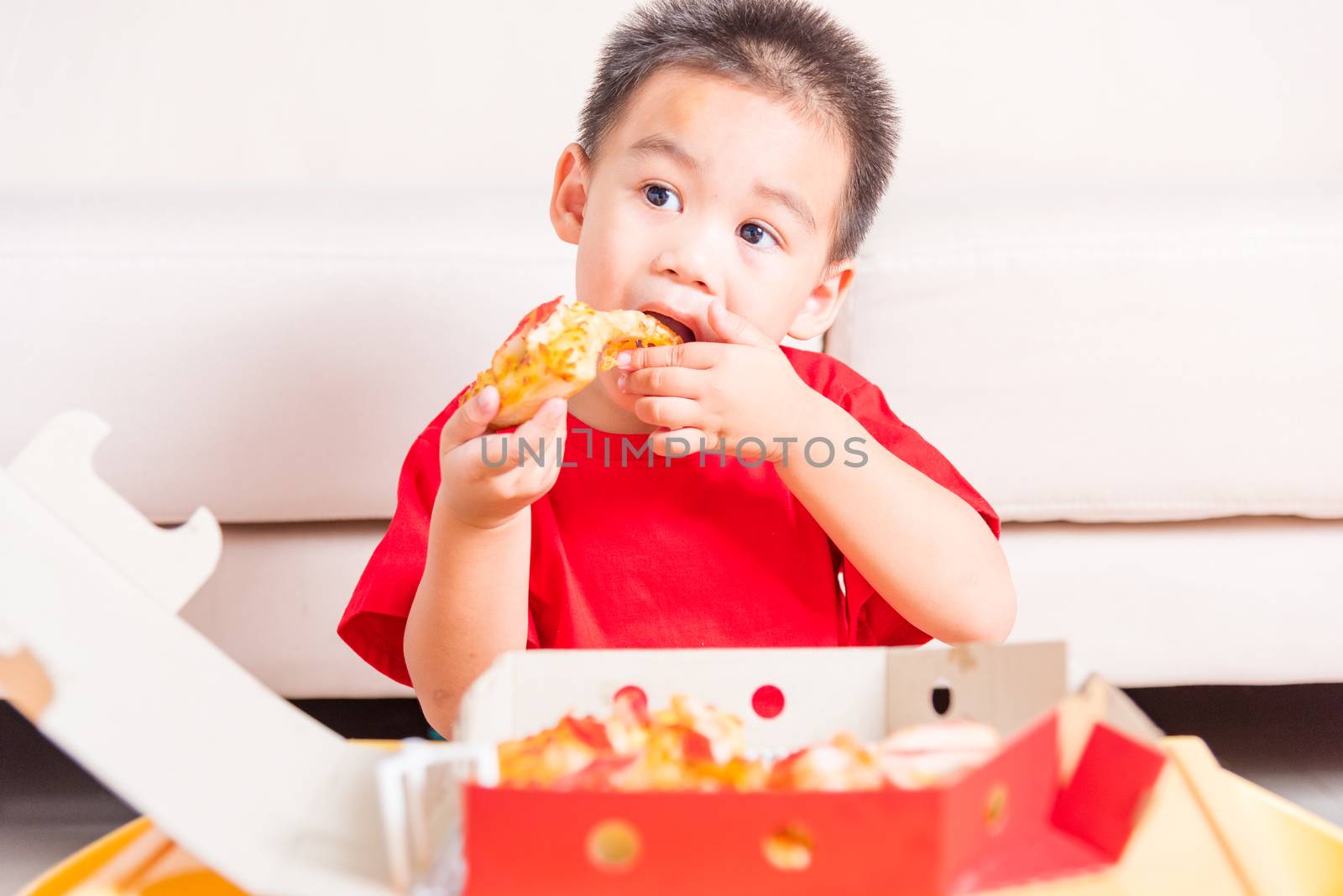 Hot Homemade, Vegetarian fast Italian food, Cute Little Child enjoying eating Delivery Pizza pepperoni, cheese many slices deliciously in an open cardboard box at home