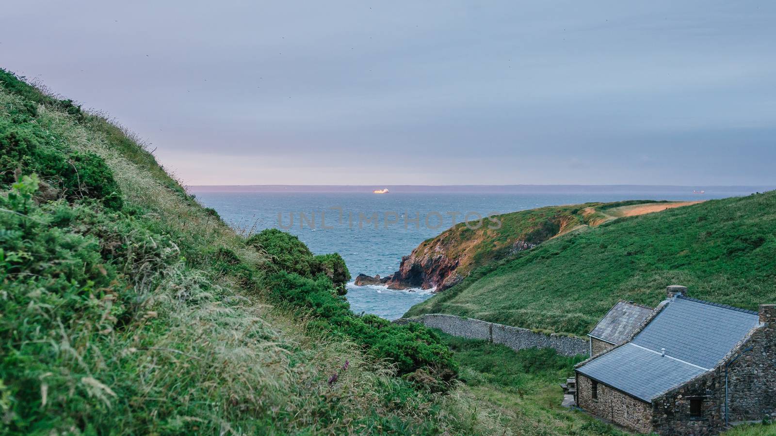 Sunset view over Dale Princess port starting point in St. Brides Bay from the hill side in Martin's Haven in Pembrokeshire, West Wales. by tamas_gabor