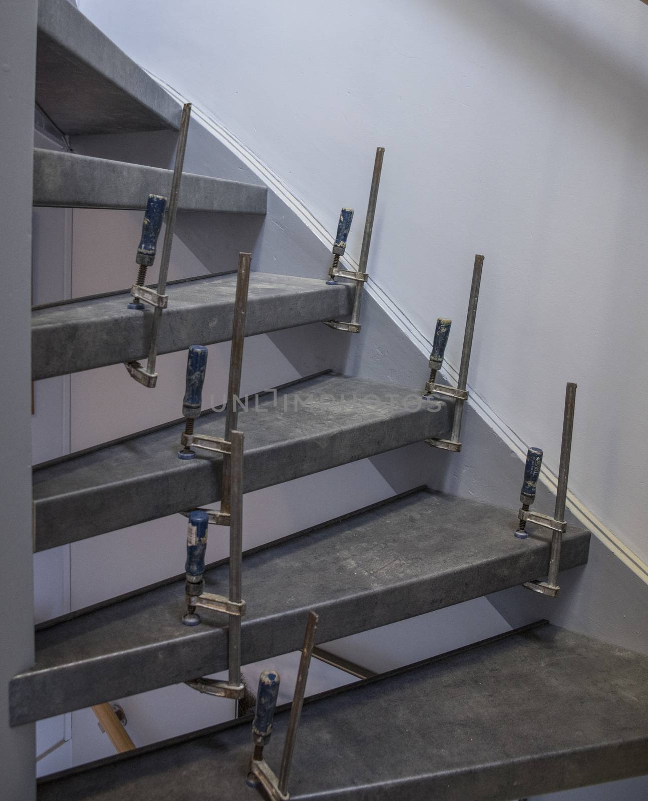 glue clamps during stairs renovation with wall background