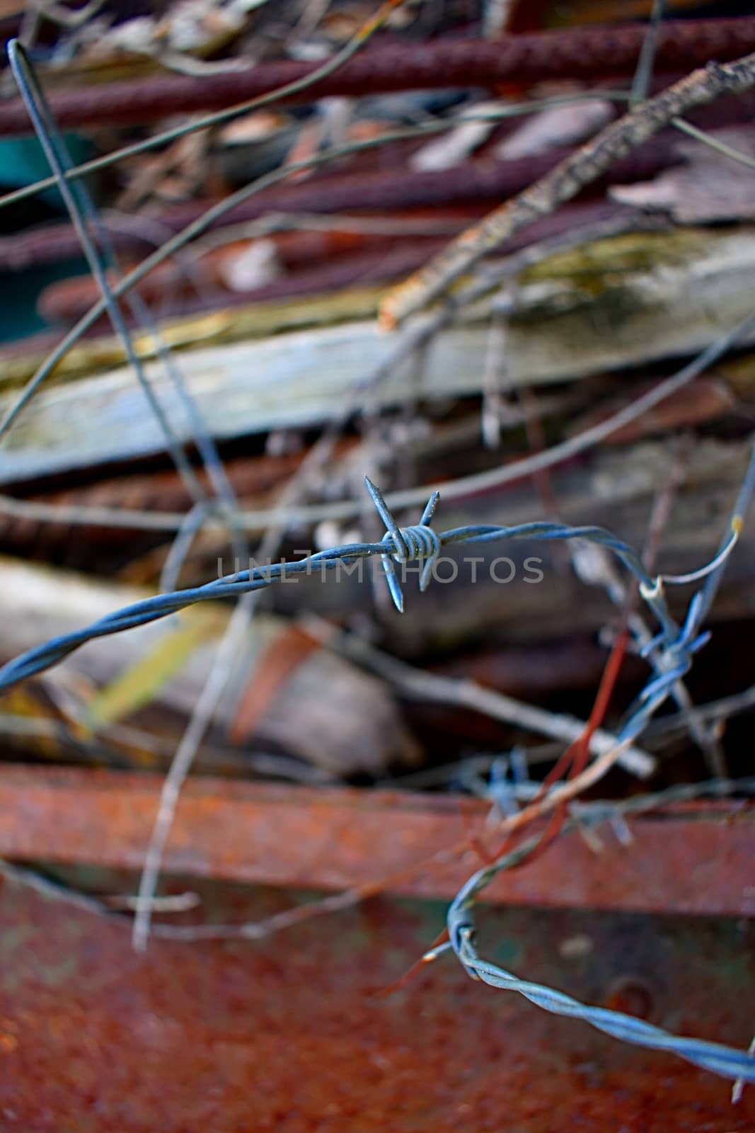 A close up of barbed wire sitting in a rusty trailer