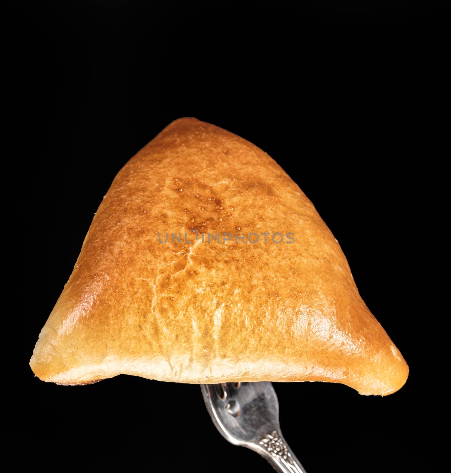 Pie on a fork on a black studio background