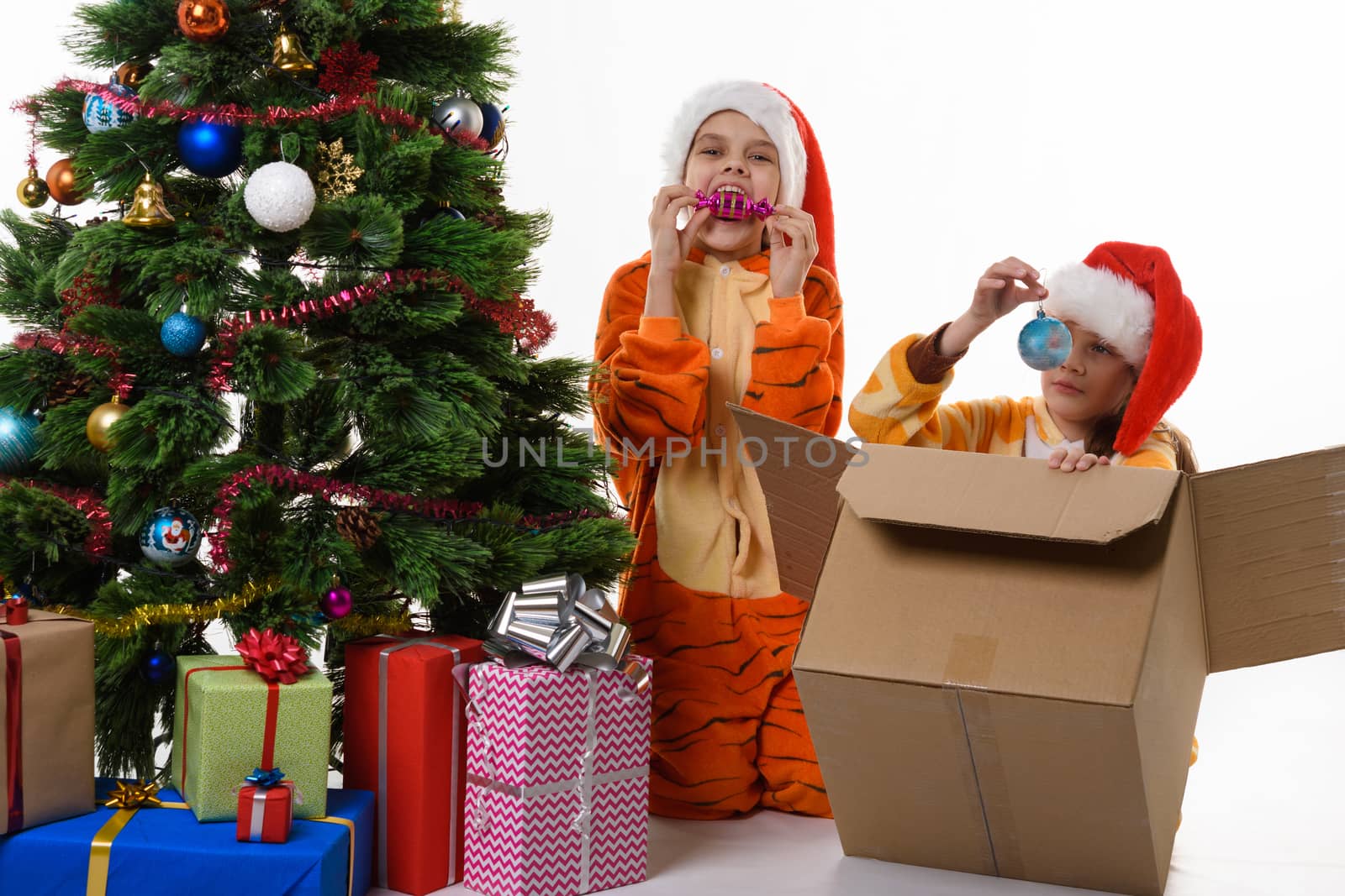 Two girls fooling around and looking at Christmas toys