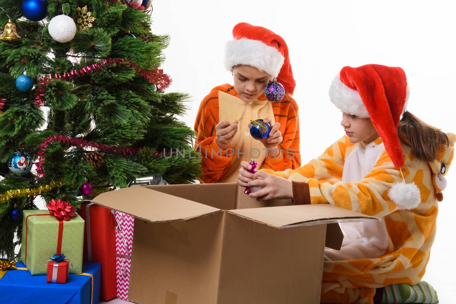 Children make out a box with New Year's toys