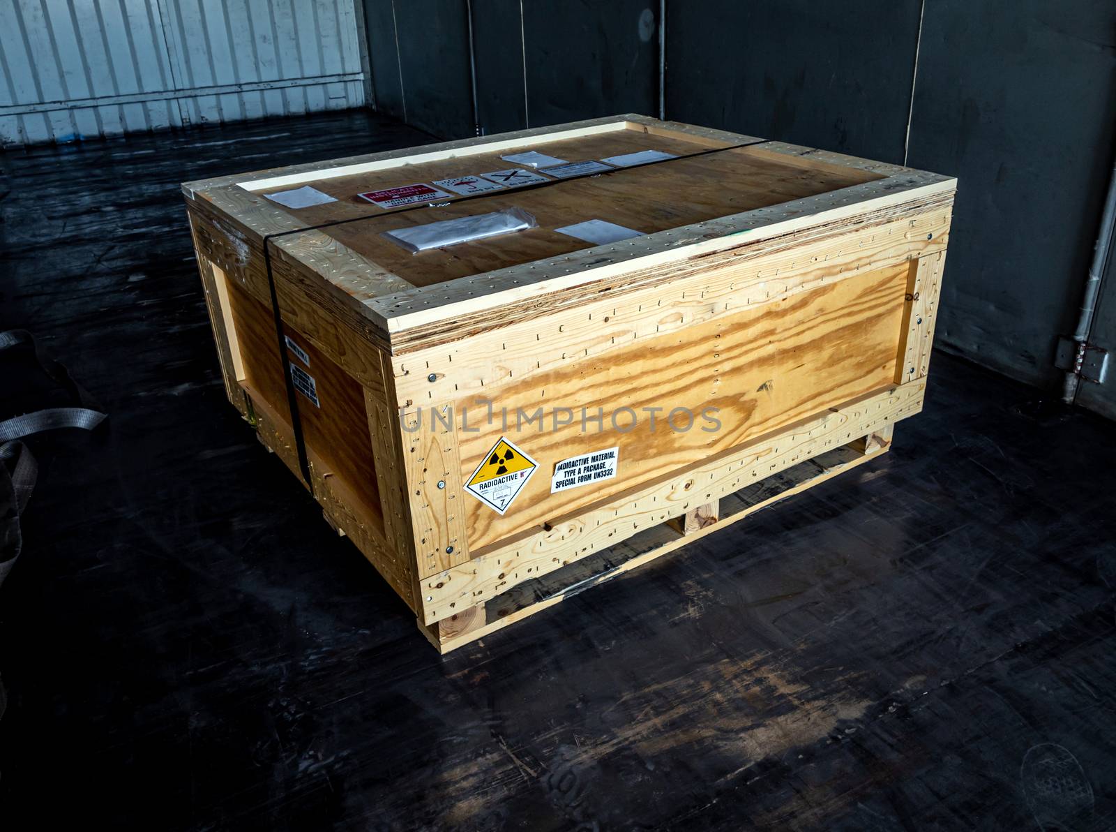 Radiation warning sign on the Hazardous materials transport label Class 7 at the wooden box Type A standard package in the container of transport truck