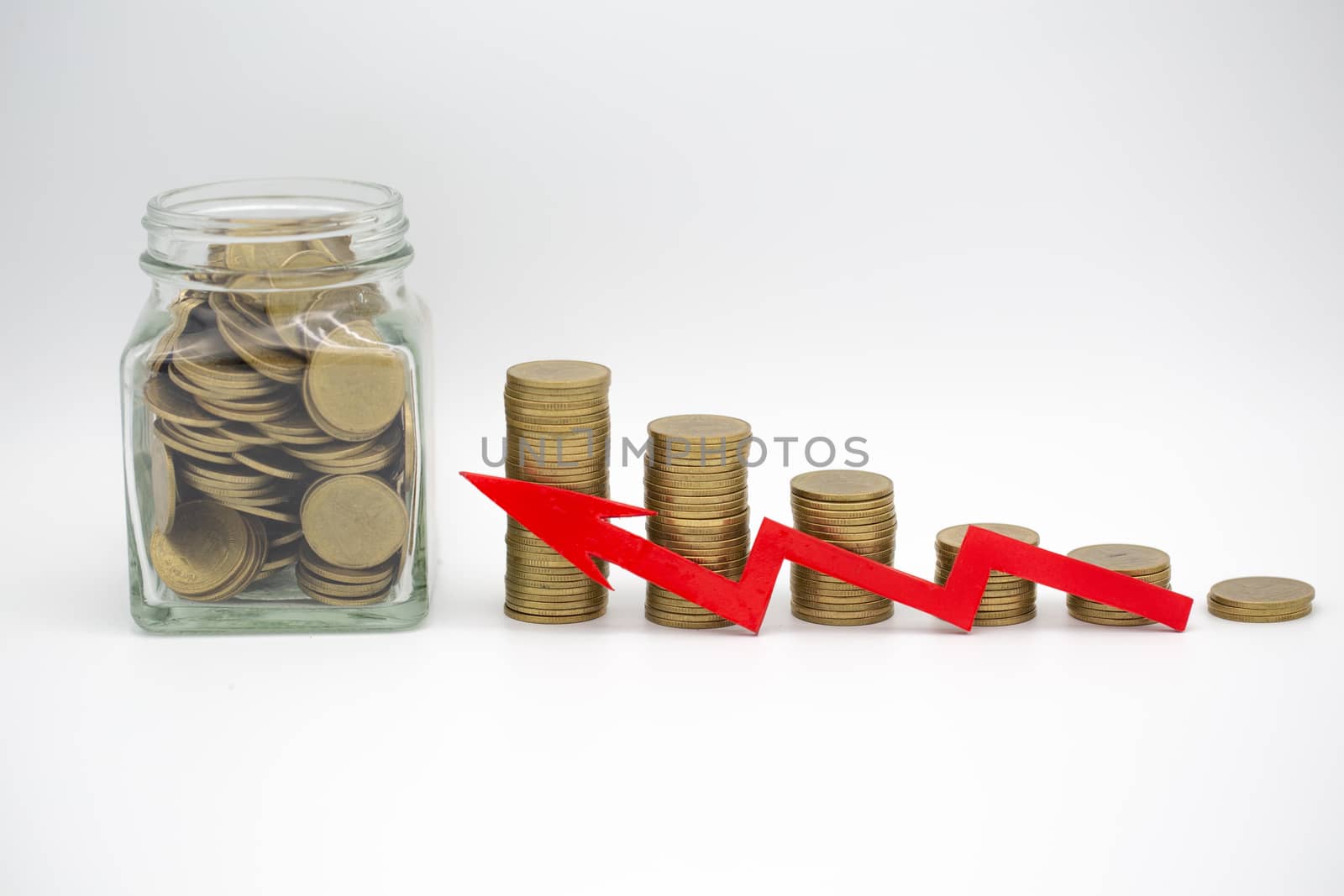 A coin in a glass bottle Ladder of coins. White background. The red arrow placed in front of the coin, the more economic ideas for high profits for investment businesses and monetary funds represents.