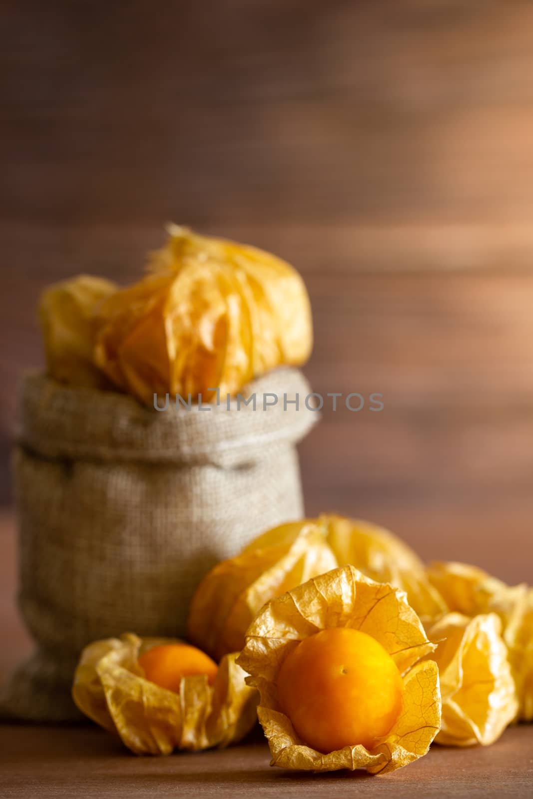 Cape gooseberry in burlap bags. Concept of health care or herb. Closeup and copy space for text.