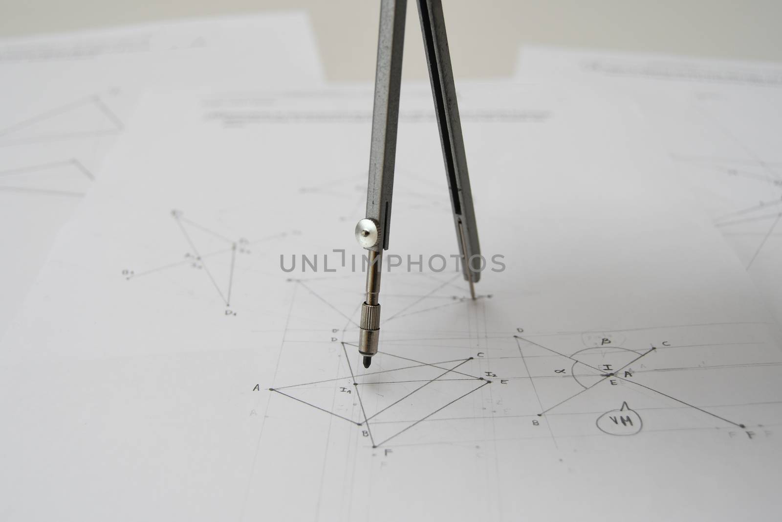 Technical drawing with drafting compass, papers