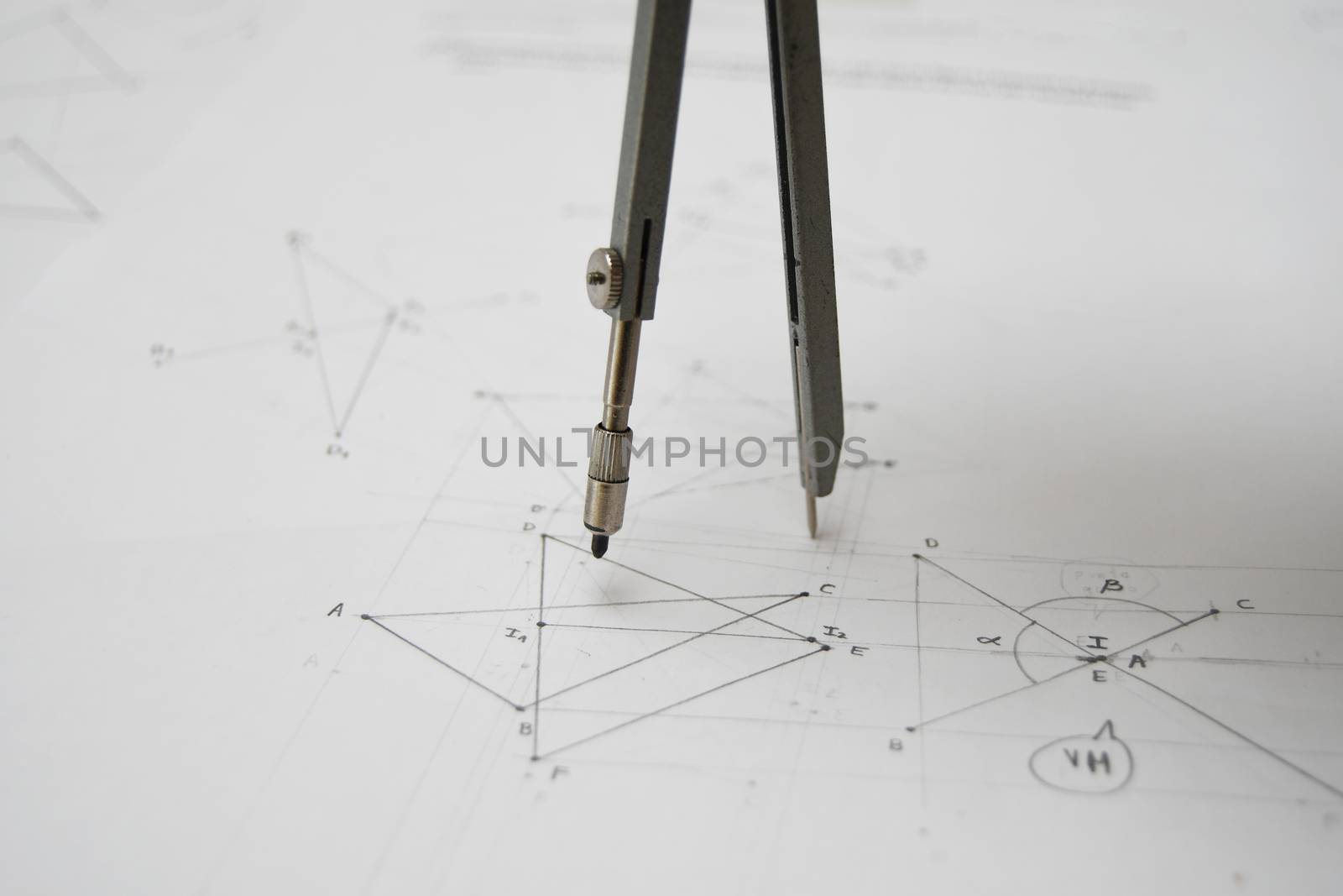 Technical drawing with drafting compass, papers