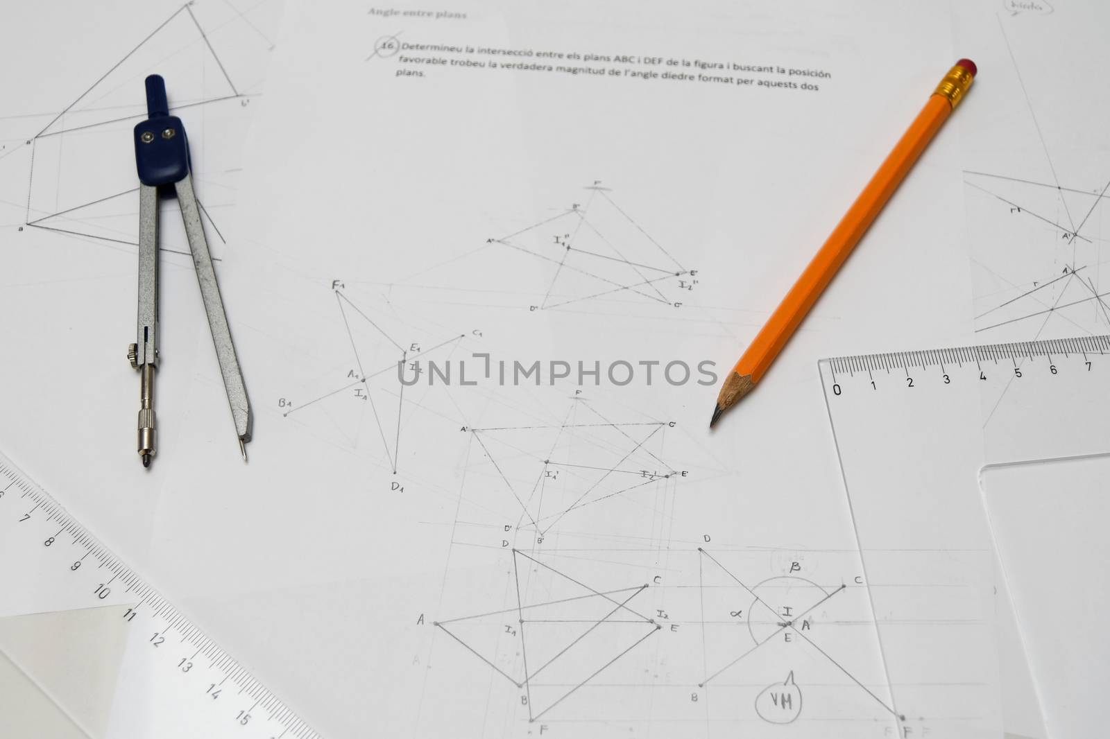 Technical drawing table with pencil, drafting compass, rulers, papers