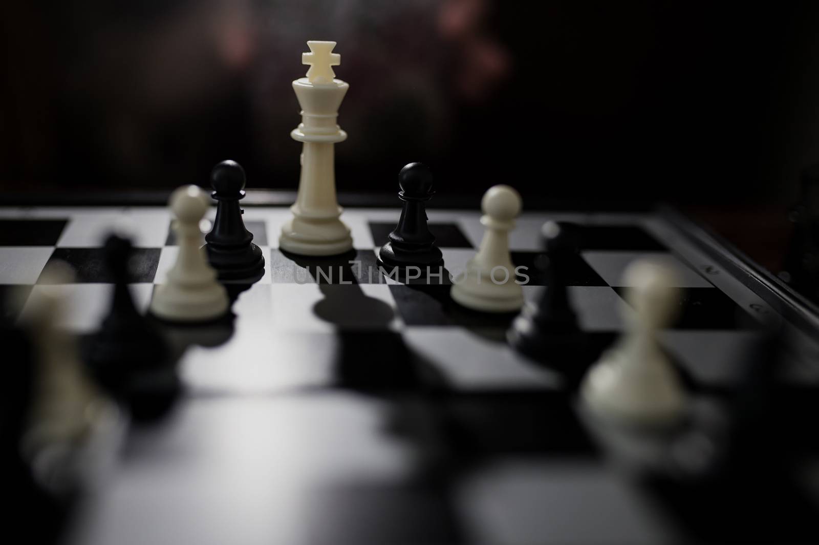 Selective focus of white queen and some black figures on chessbo by Angel_a