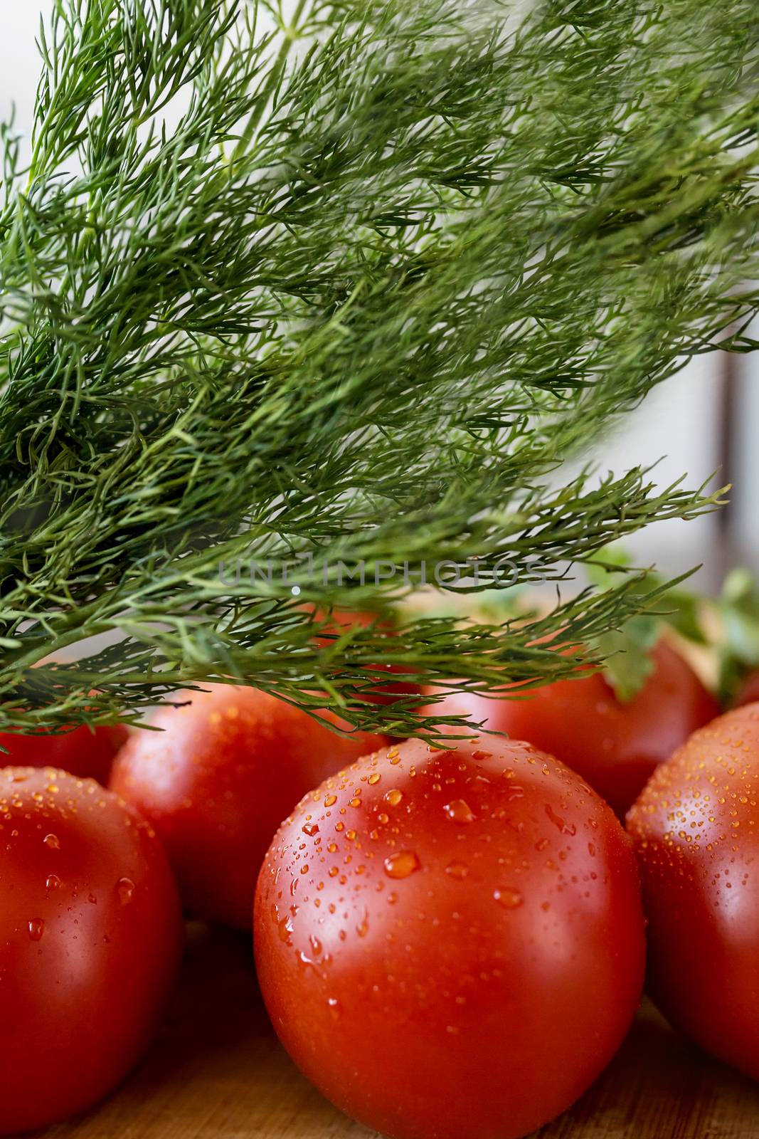 Tomatoes with parsley on table ready to do salad