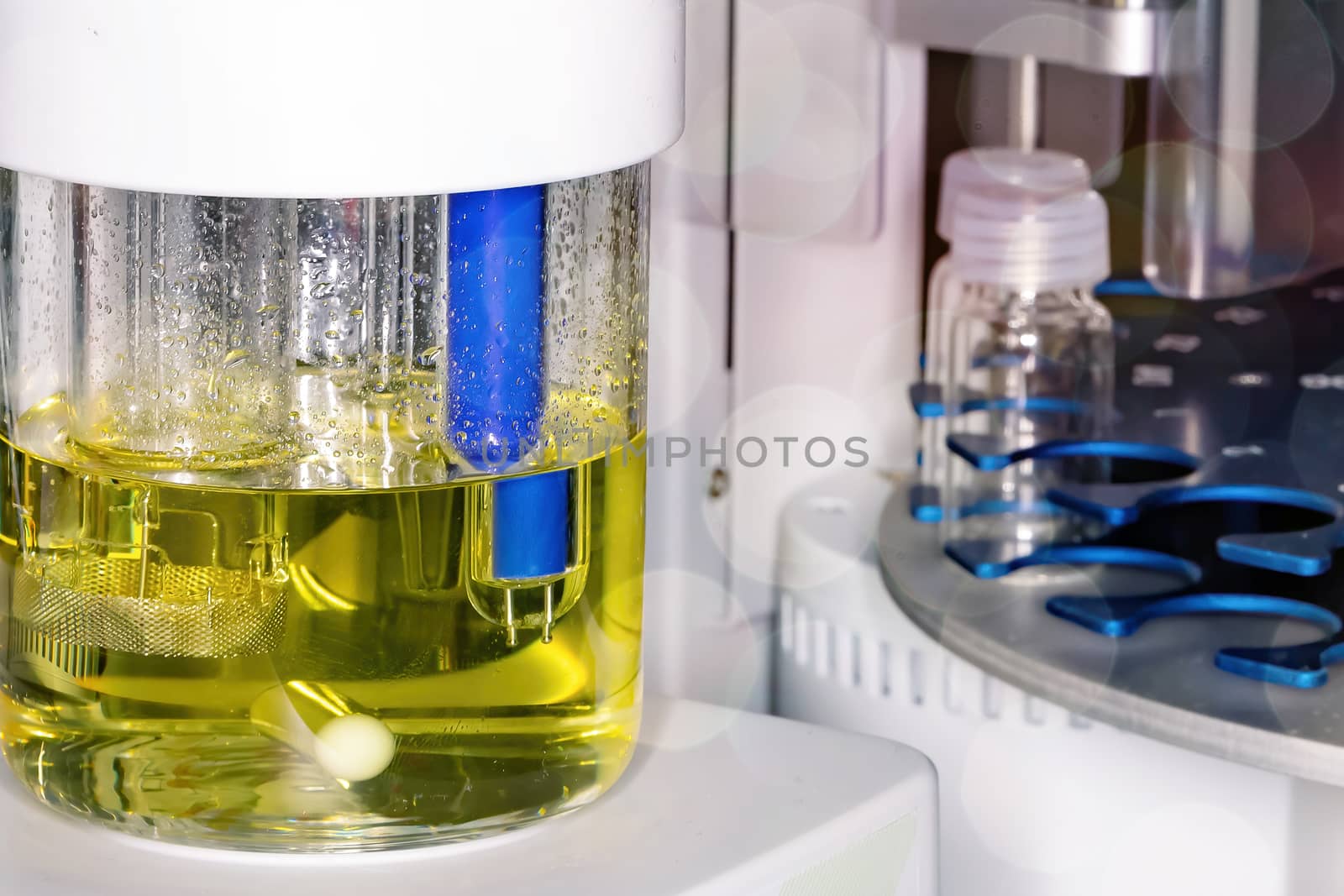 Close-up of a laboratory glass flask with a yellow liquid. The concept of scientific research and development.