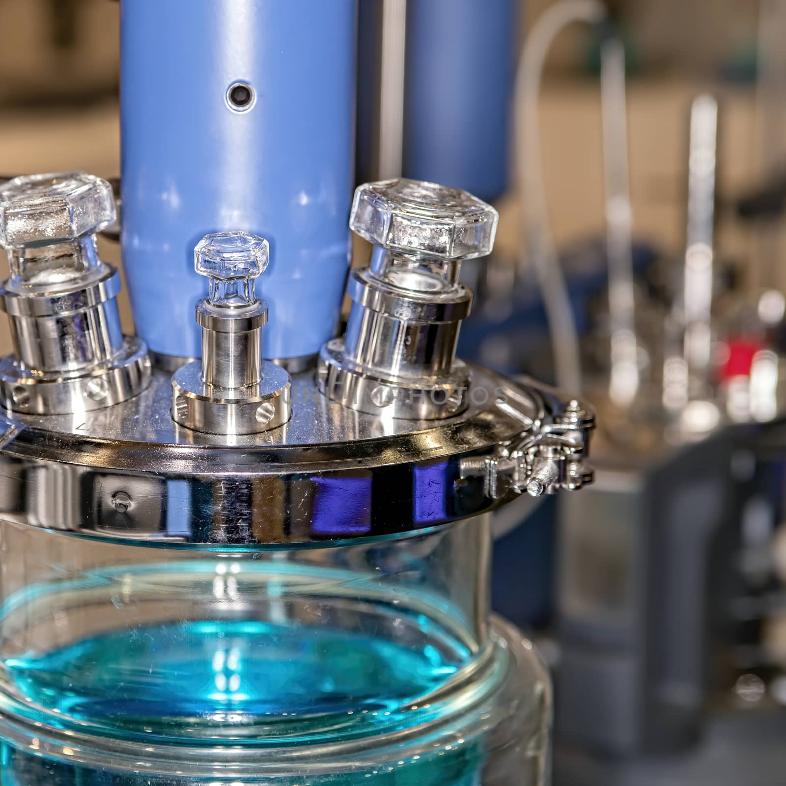 Close-up of a laboratory glass flask with a blue liquid. The concept of scientific research and development.