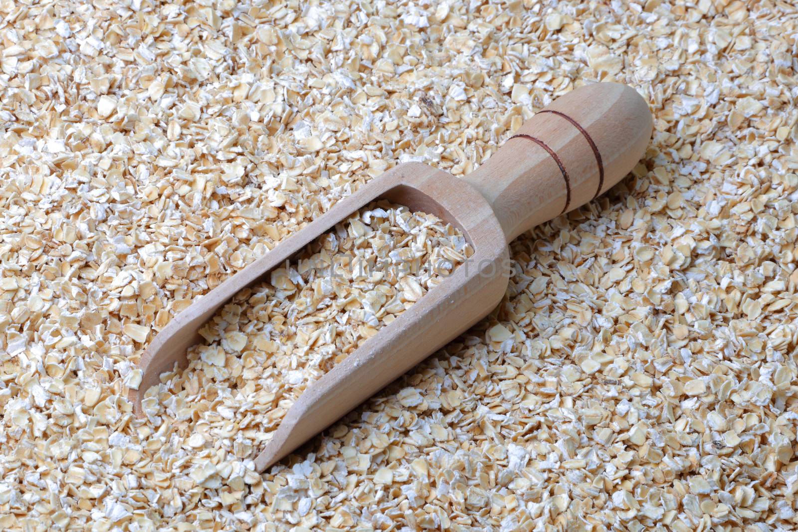 oatmeal porridge oats in a wooden scoop