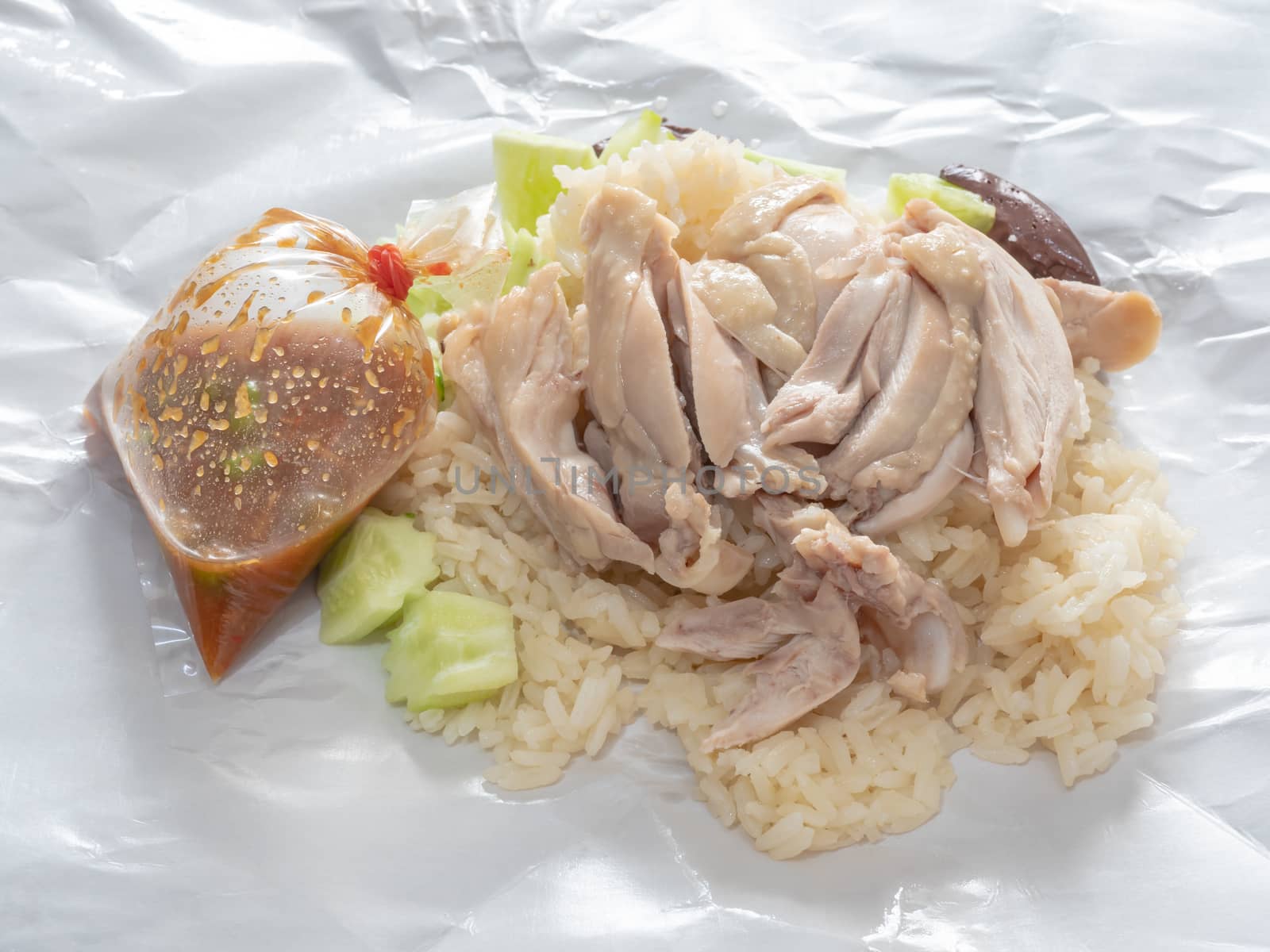 The close up of Thai chicken rice food on paper sheet.