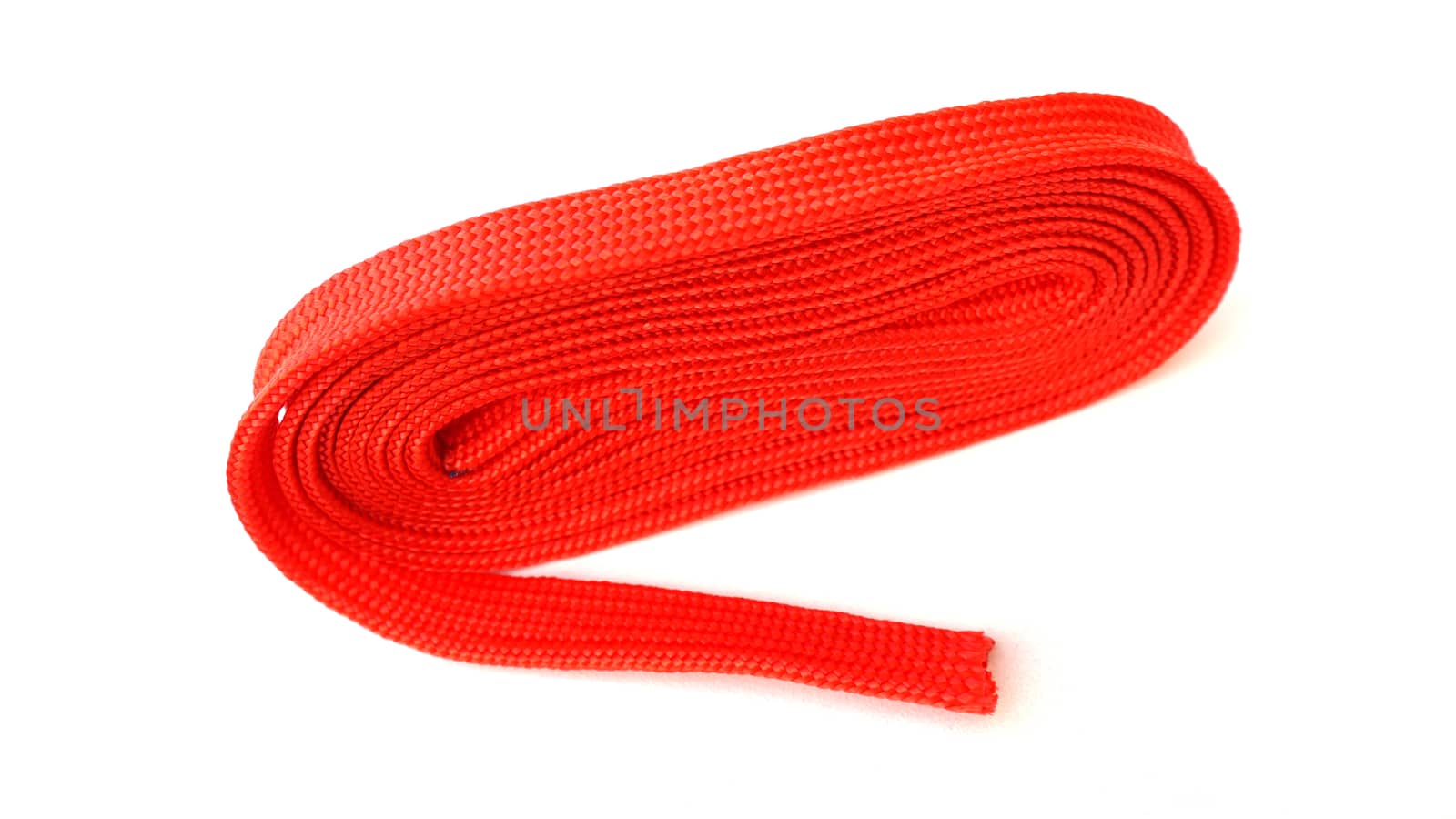 Red rope on white background. Fabric rope in red color folded in a coil.