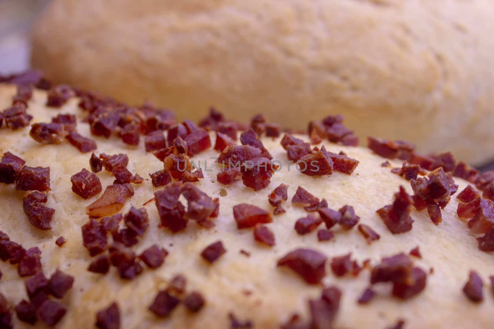 Fresh home baked breads, make out of wheat, one simple and one with pepperoni on top