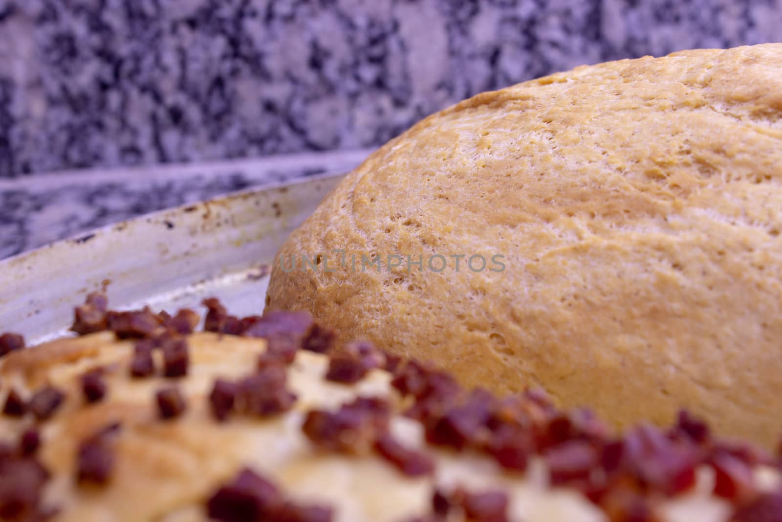 Fresh home baked breads, make out of wheat, one simple and one with pepperoni on top