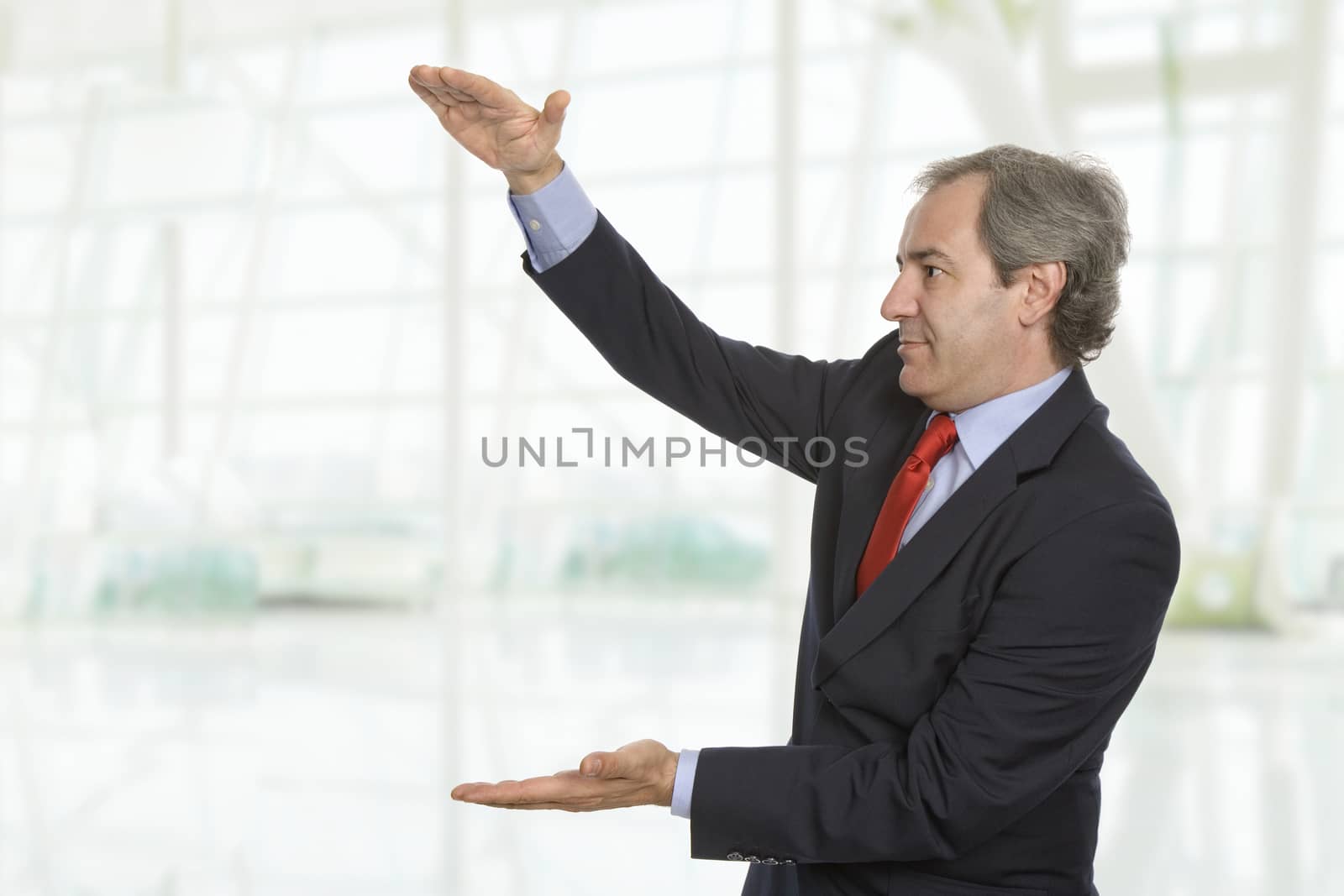 friendly mature businessman presenting something at the office