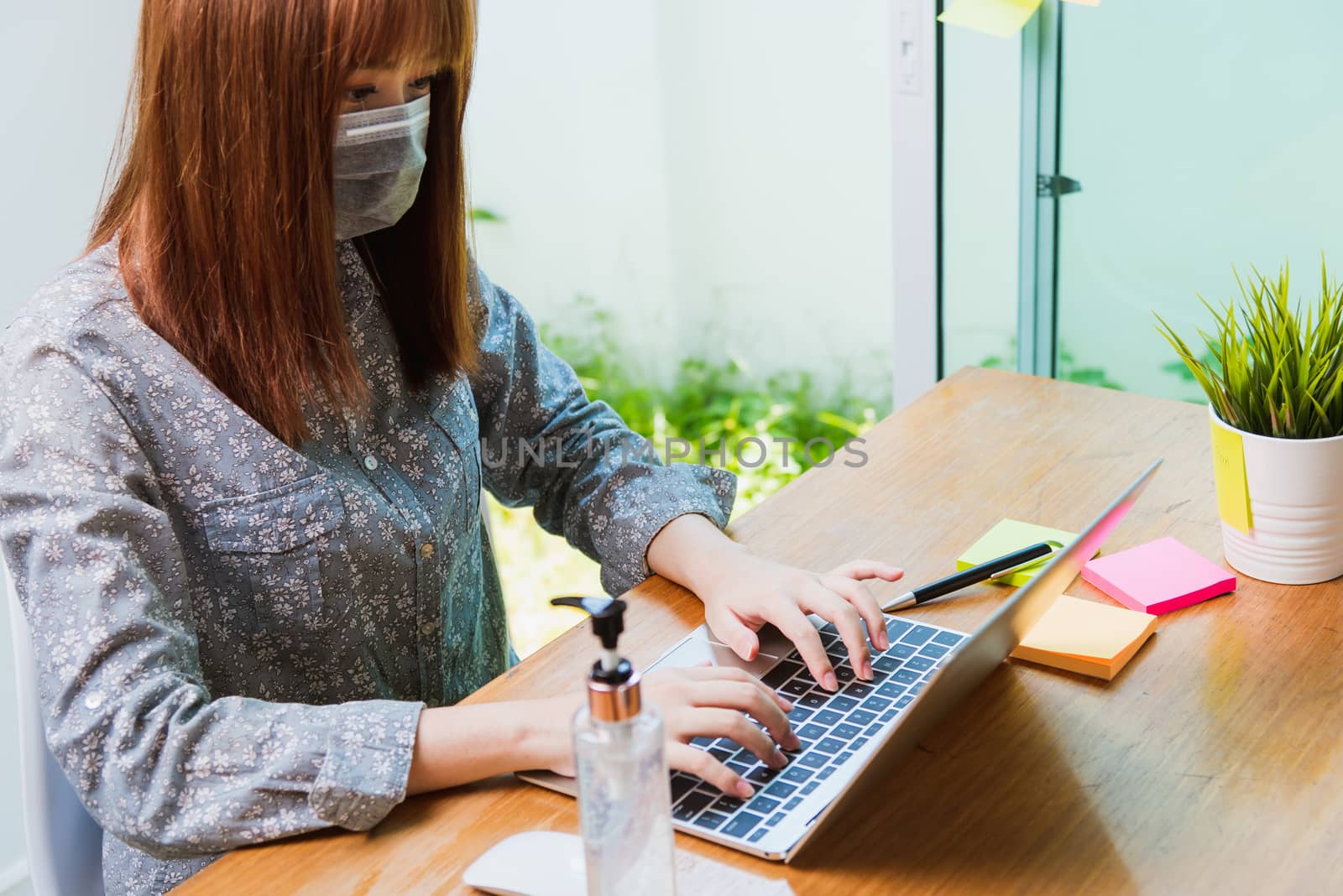 woman work from home office he wearing a protective mask with di by Sorapop