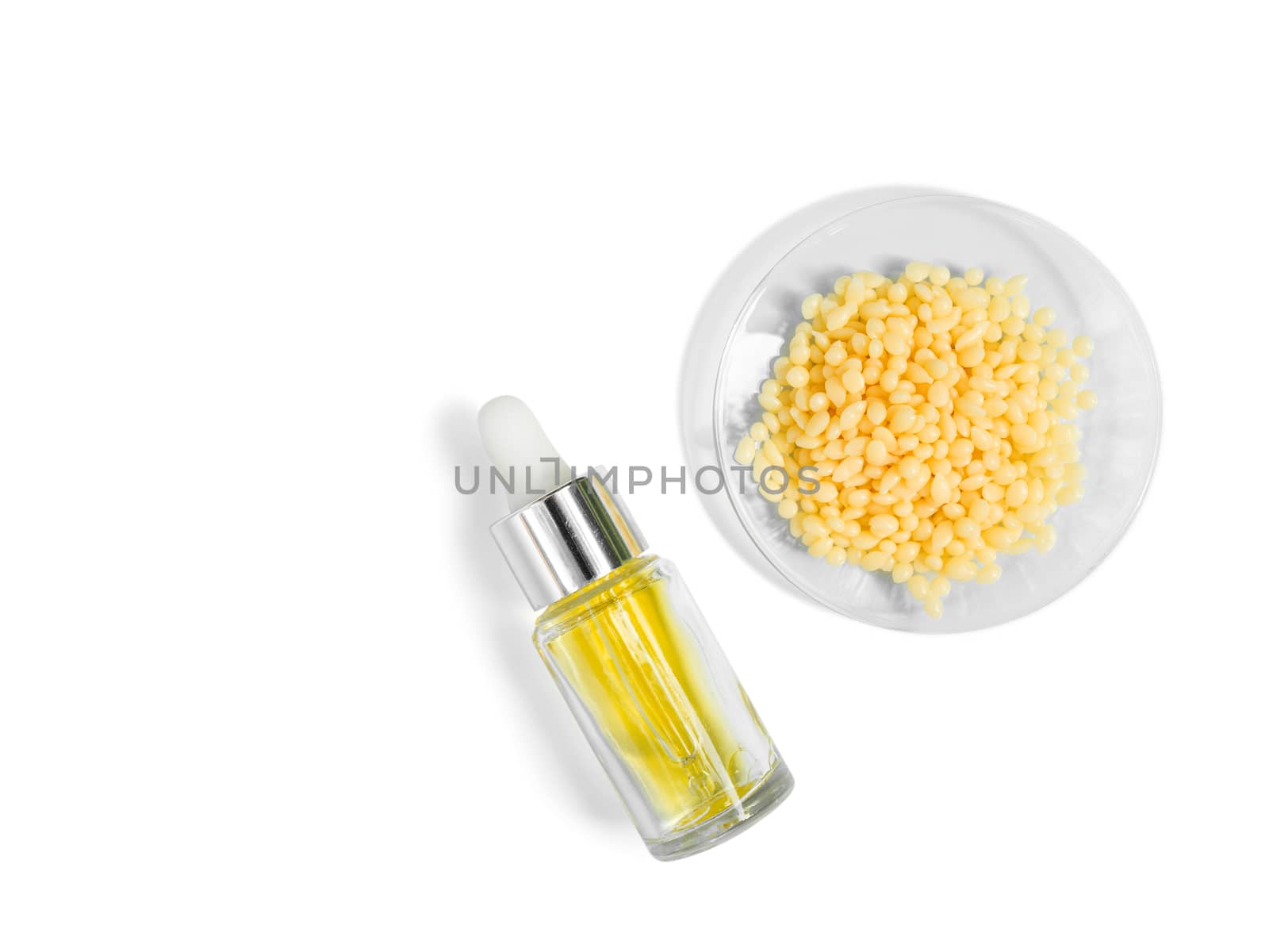 Candelilla Wax SP-75. Chemical ingredient for Cosmetics & Toiletries product. Yellow cosmetic color (oil). Chemicals for beauty care on a white background. (Top View)