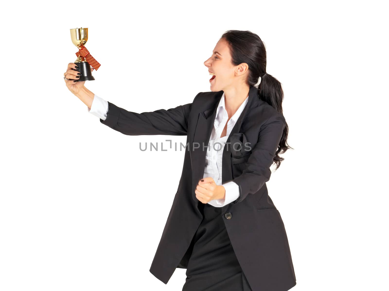 A businesswoman in a black suit with a smile looking at the trophy received from the work done proudly. Portrait on white background with studio light.