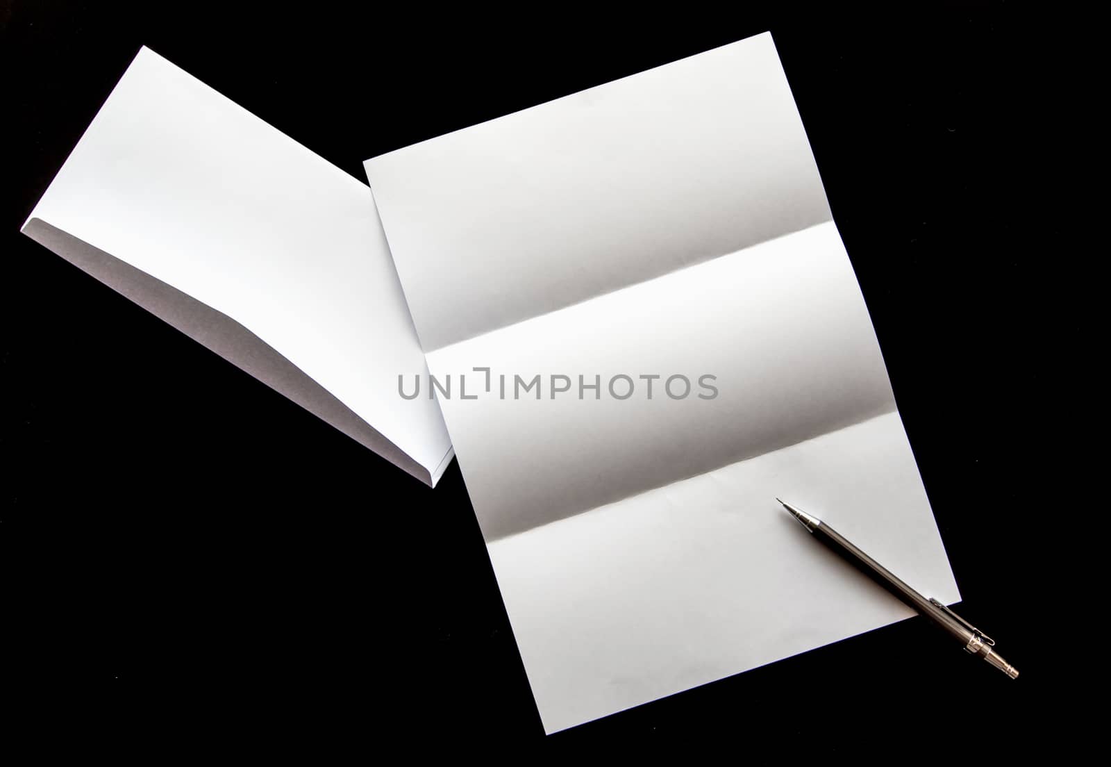 blank of letter paper and white envelope with pen by Satakorn