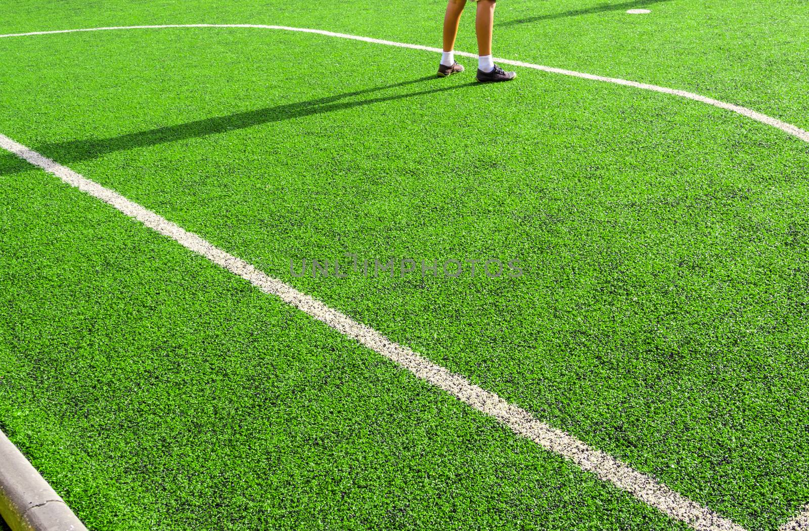 Child play on the artificial turf of the school