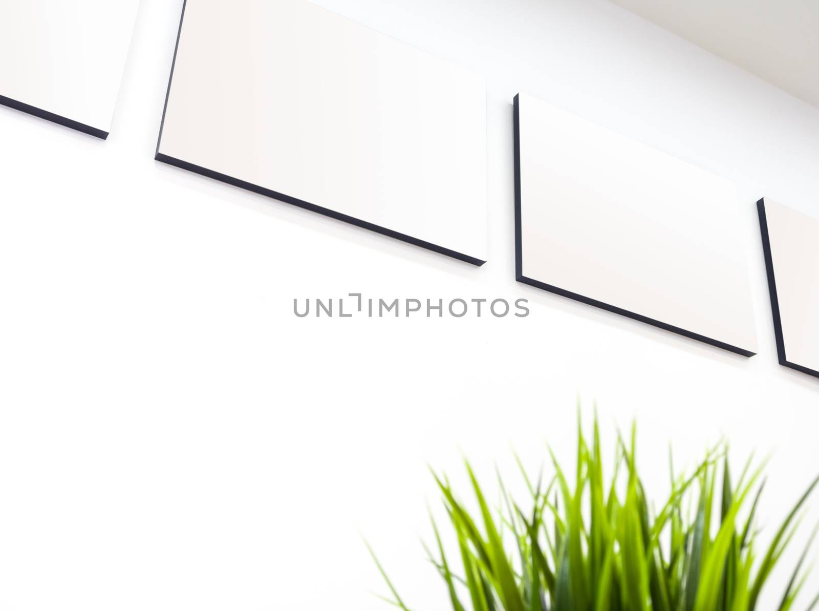 The blank canvas picture frame on the wall by Satakorn