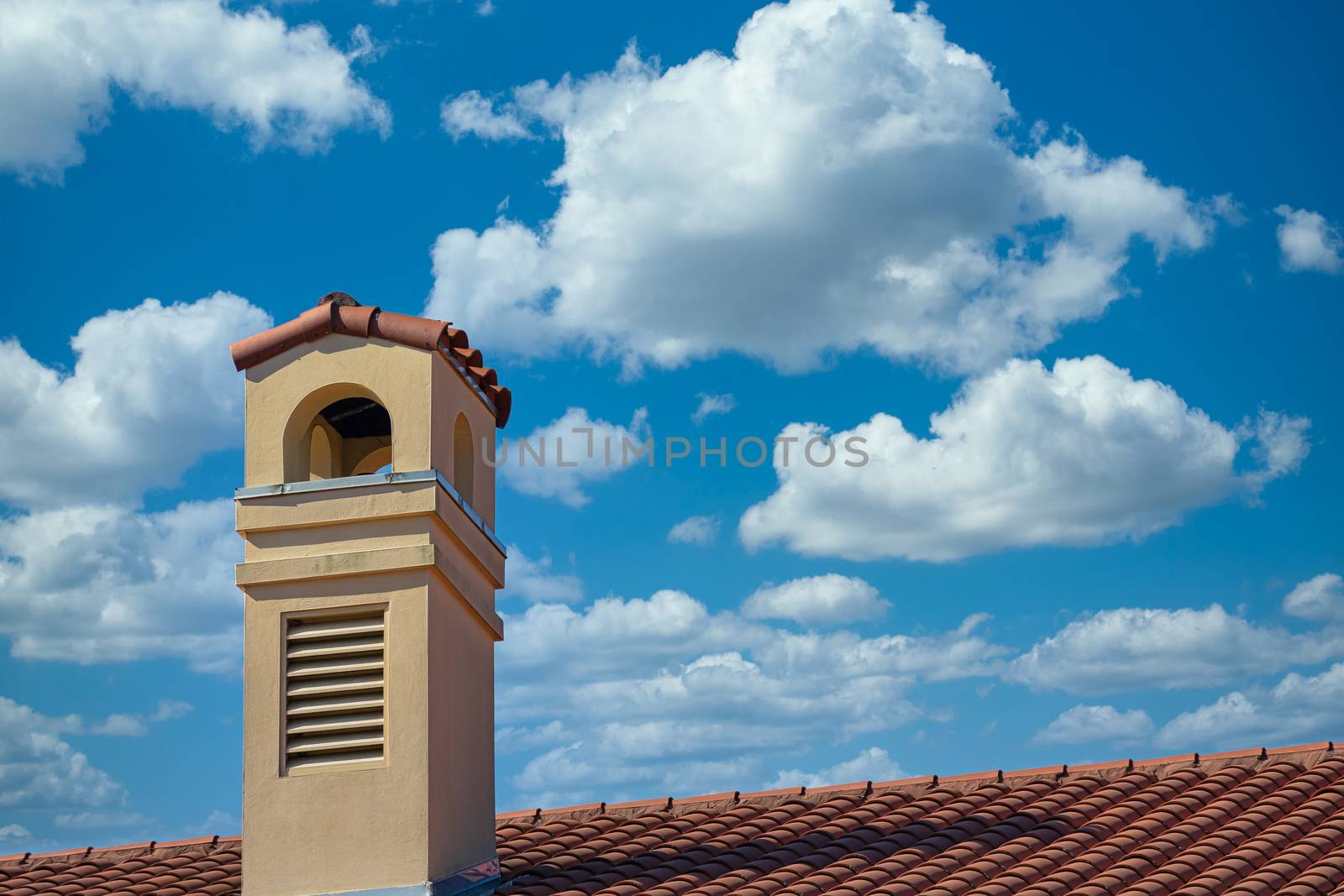 Plaster tropical resort hotel with a red tile roof