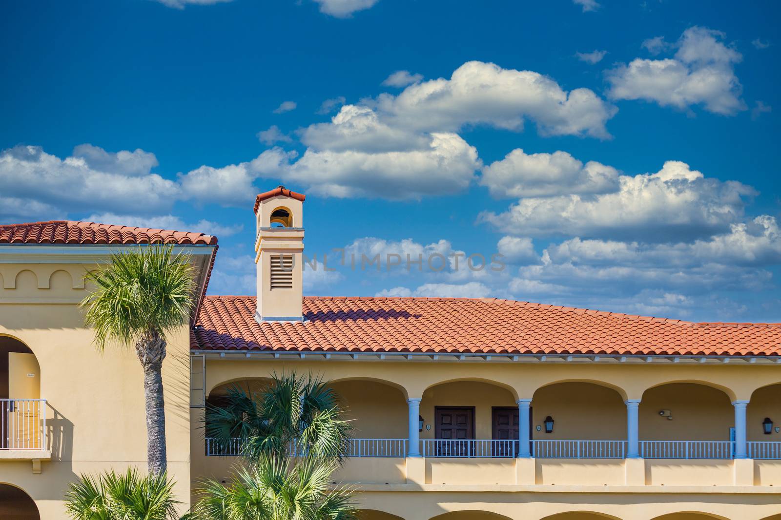 Plaster tropical resort hotel with a red tile roof