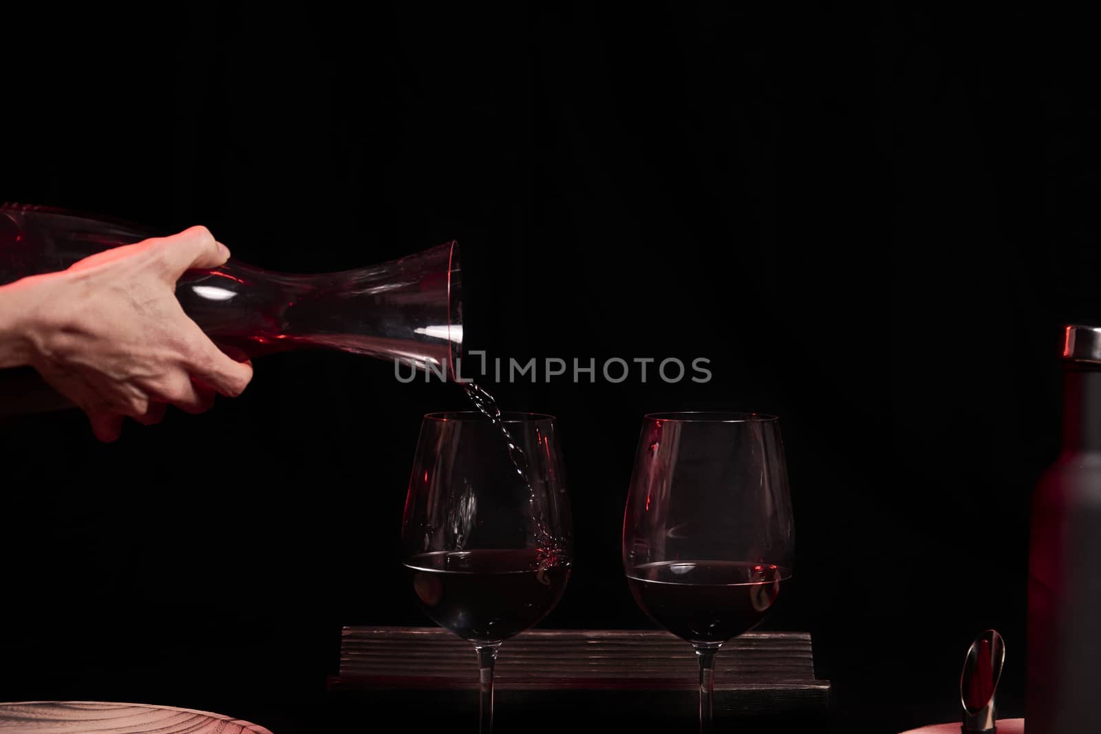 Pouring two glasses of wine on black background by raul_ruiz