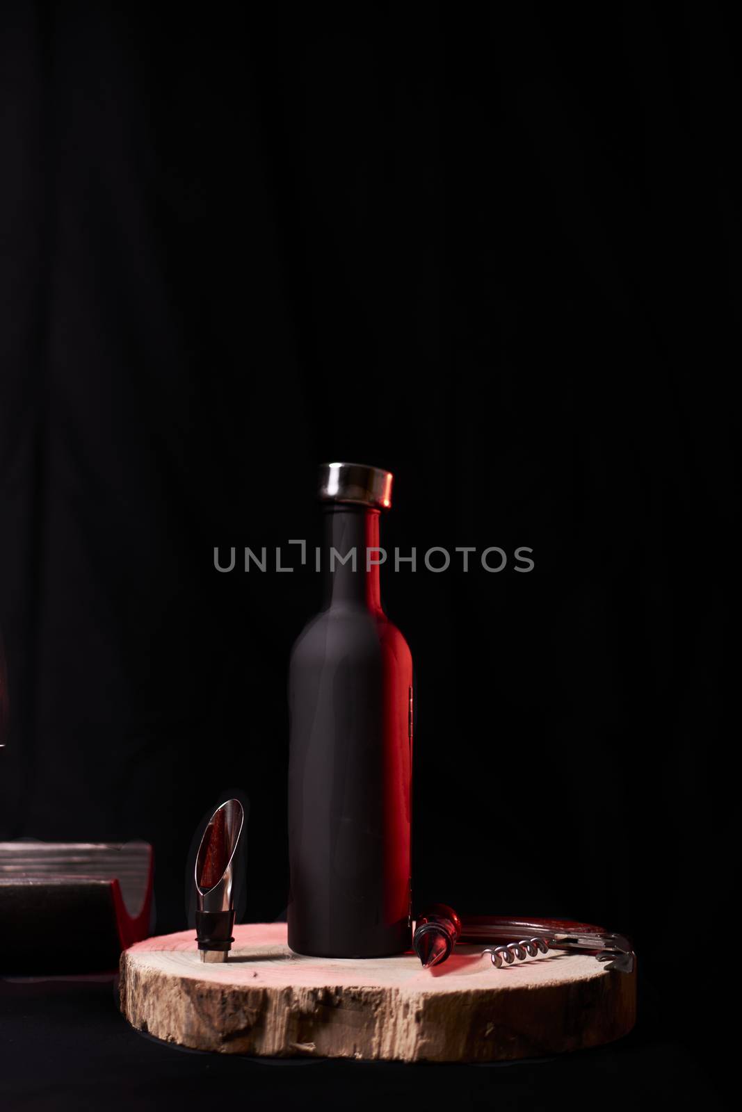 Bottle and wine utensils on wooden stump by raul_ruiz