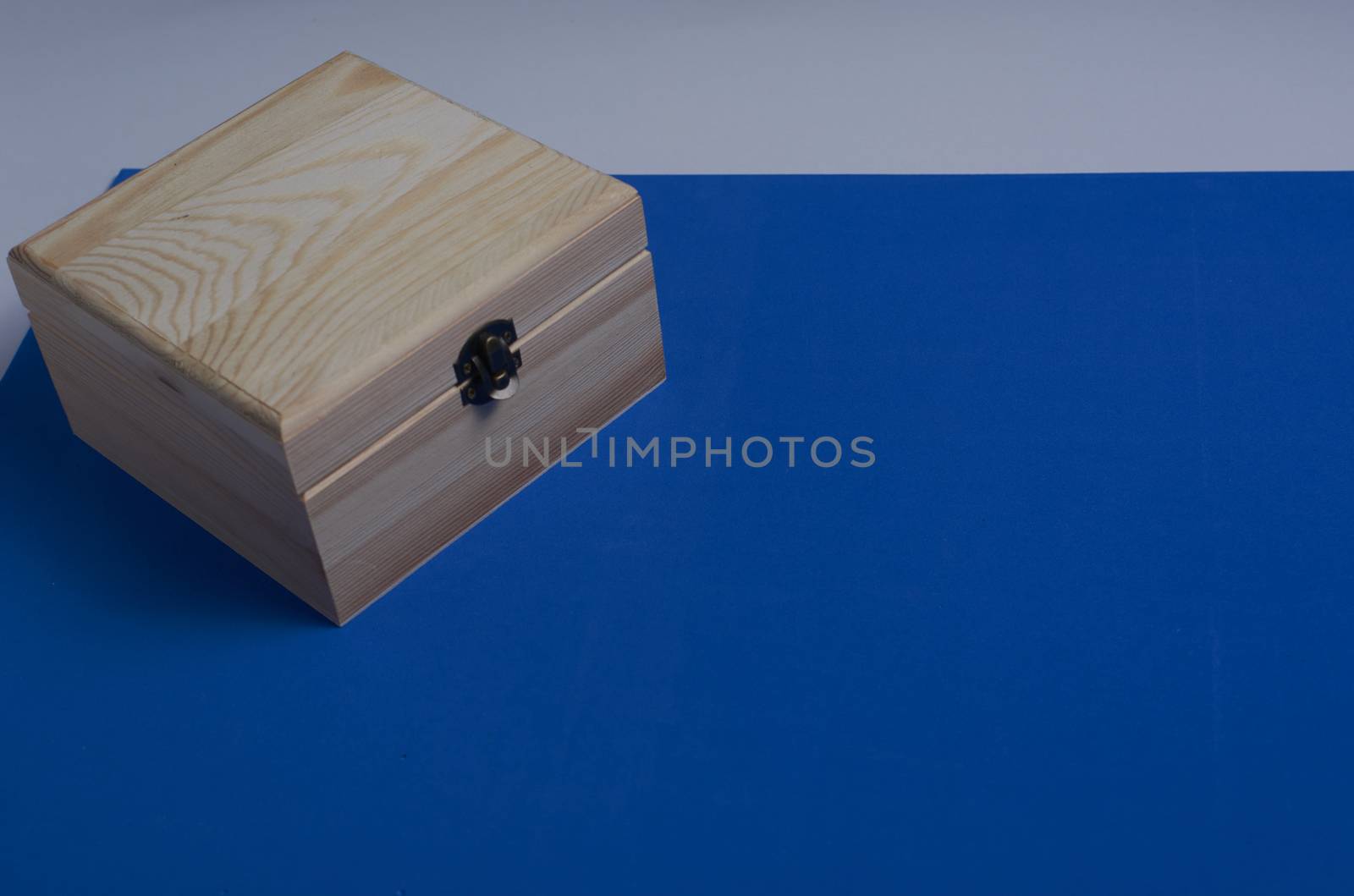 Wooden box on blue mat background for secrets.