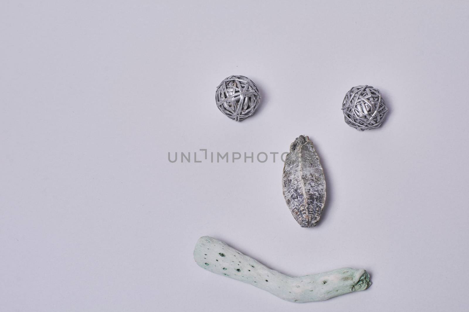 Wooden ornaments put on white background to imitate a smiling face