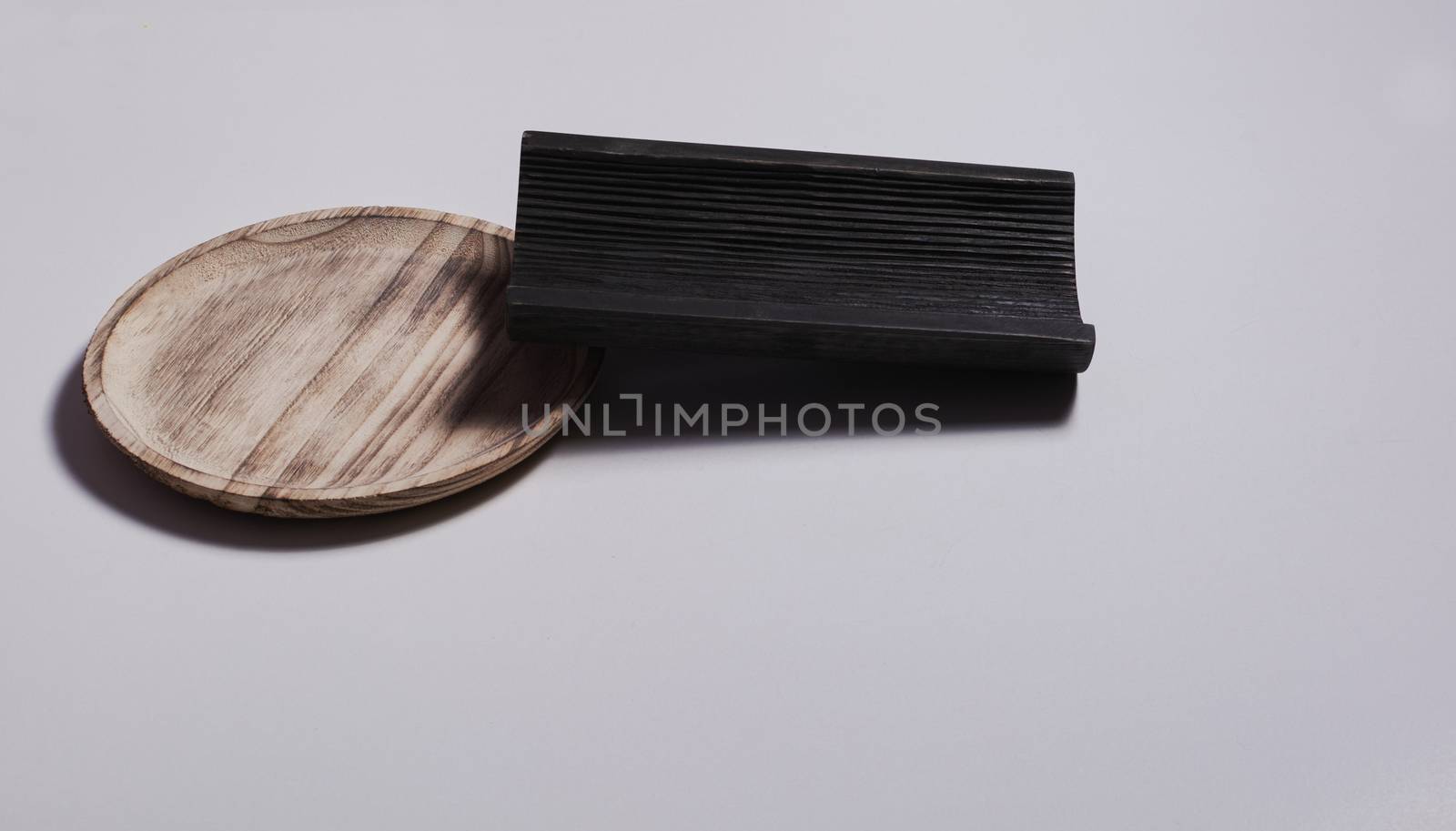 Wooden plate with a wooden tile on white background. Colors of nature