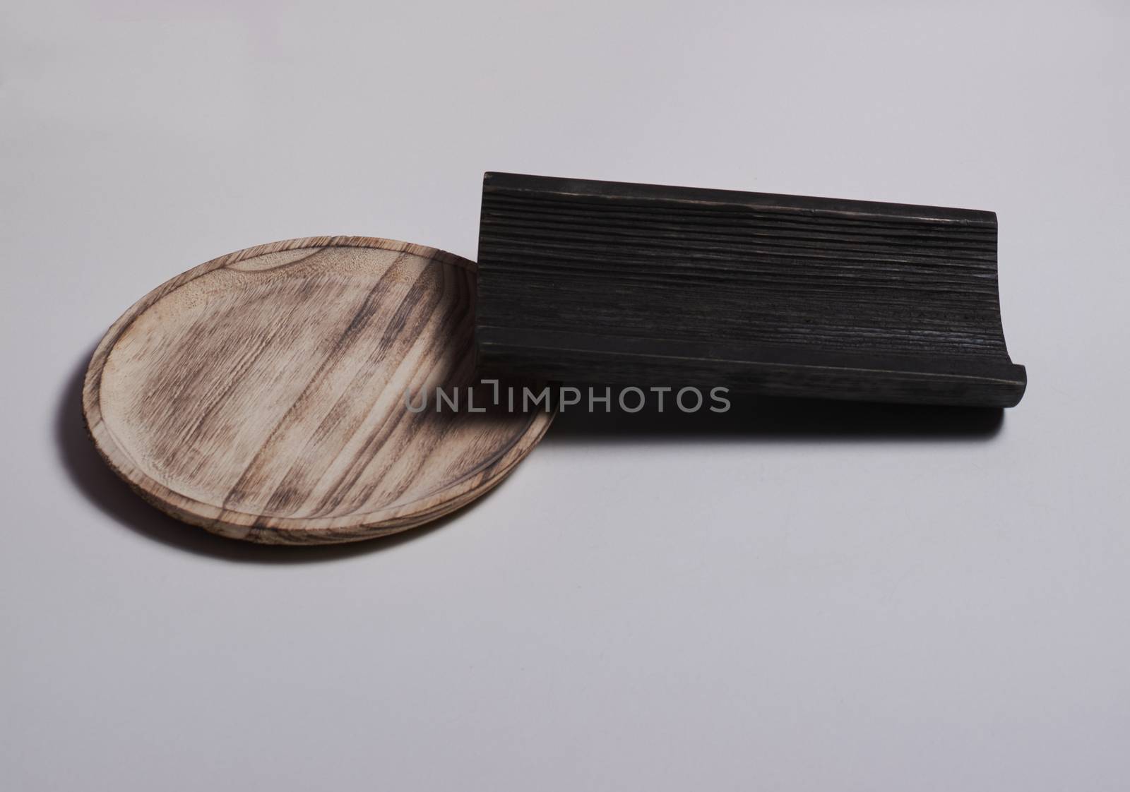 Wooden plate with a wooden tile on white background. Colors of nature