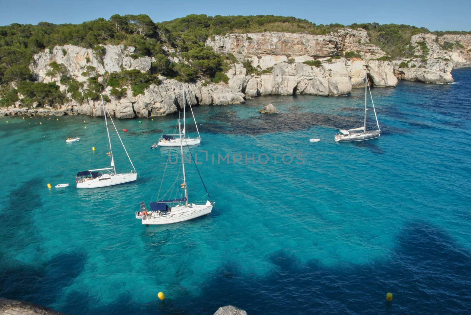 Sailboats waiting in the calm and blue sea by raul_ruiz