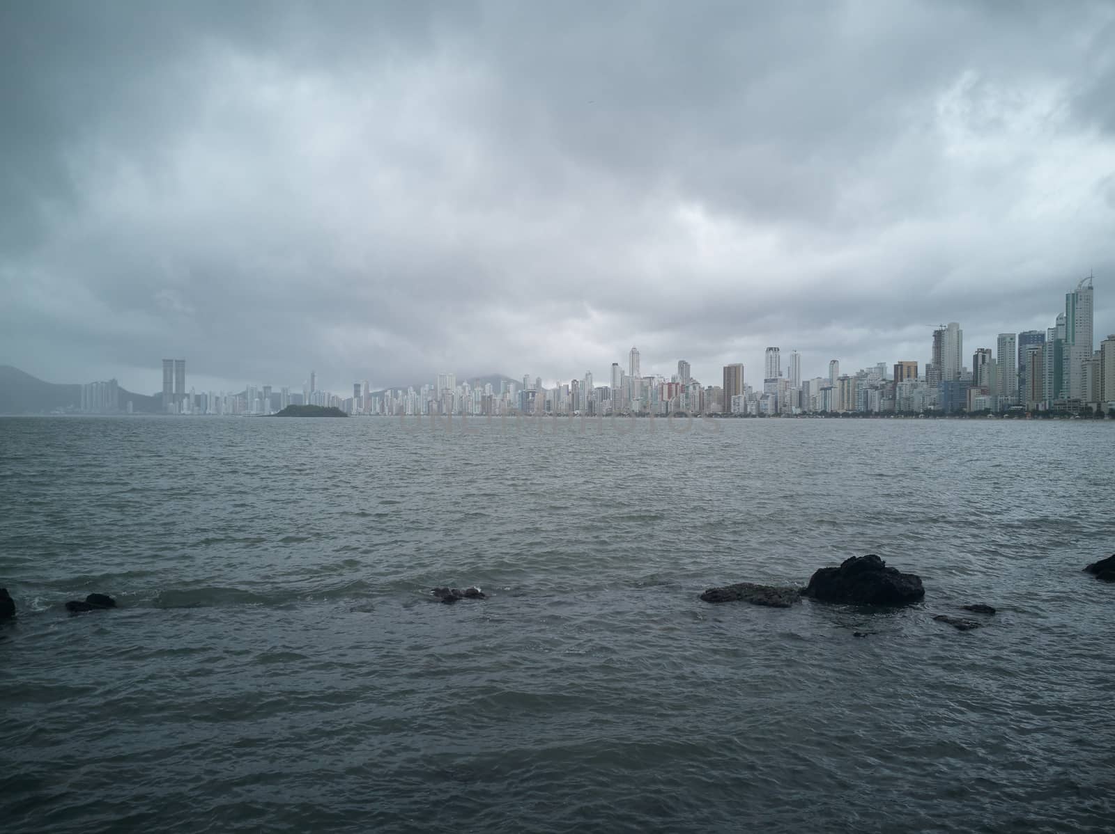 Skyscrapers after the storm on the beach. Storm colors