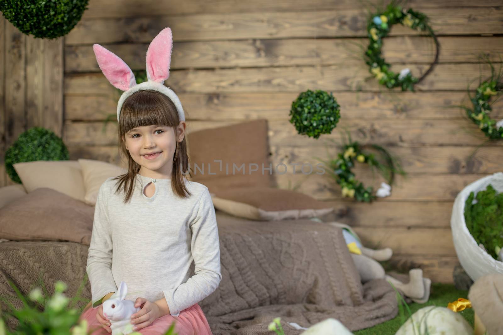 Child girl with Easter eggs in decorated studio by Angel_a