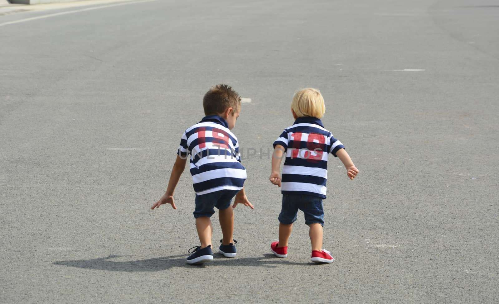 Children preparing for a fun street race. Friendship and love