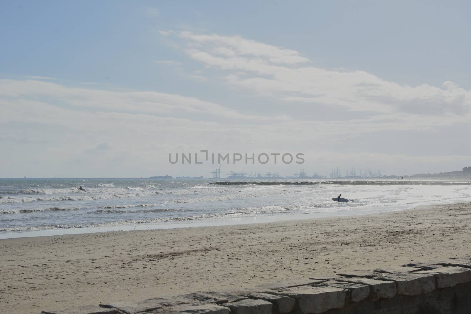 Group of surfers on the beach on a summer day. Colors of nature