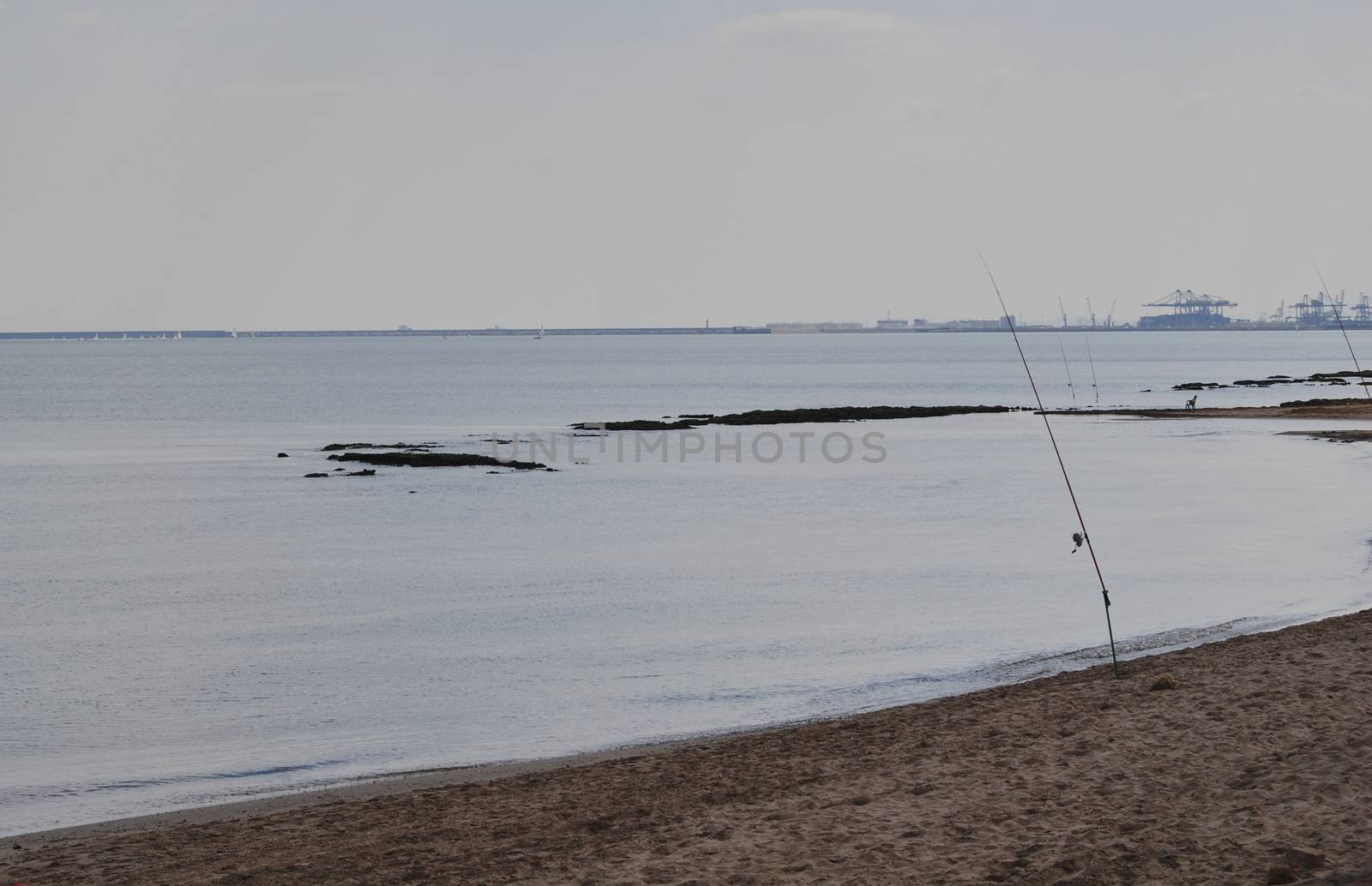 Fishing rods on the shore of the beach by raul_ruiz