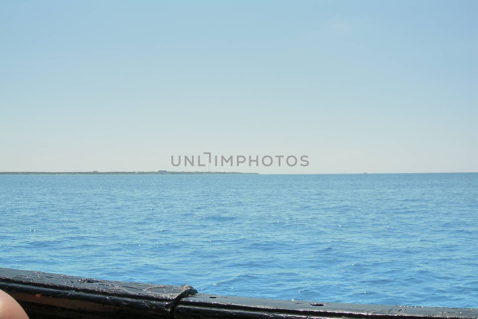 View of the Caribbean Sea from the deck of the ship.Turquoise waters and cloudless blue sky