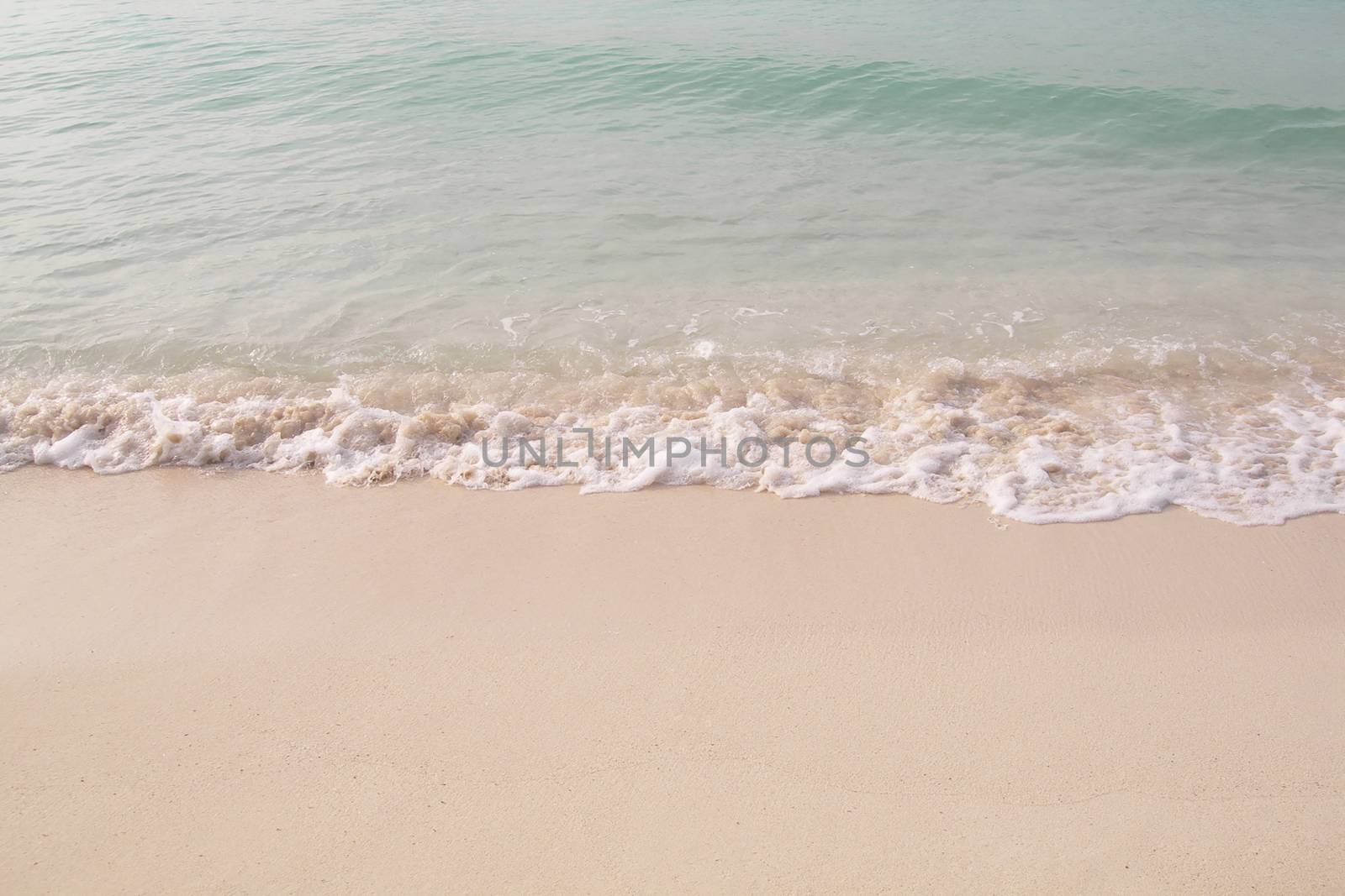 Small waves reaching the shore of the beach by raul_ruiz