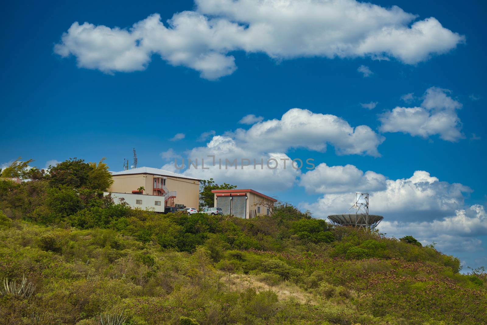 Metal Buildings on Tropical Hill with Dish by dbvirago