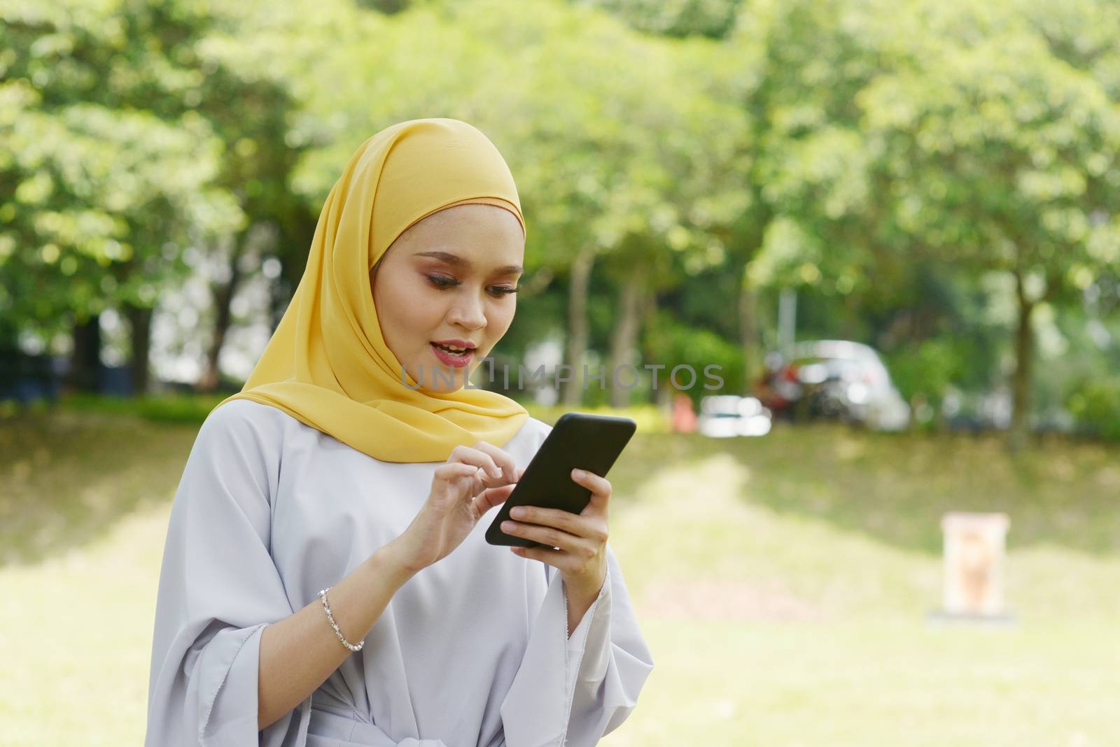 Muslim girl using smart phone by szefei