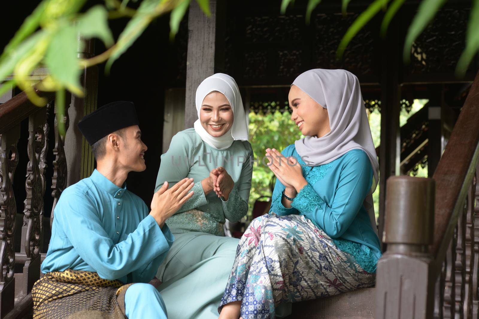 Asian Malay Muslim greetings during Hari Raya Aidilfitri. Malaysian people living lifestyle.